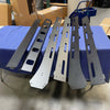 144 Sprinter Baja Roof Rack crossbars laid out on a blue moving blanket in a warehouse setting
