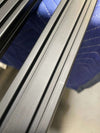 Close-up of scratched crossbars on 144 Sprinter Baja Roof Rack with textured black finish.