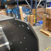 Driver Sherpa black powder-coated aluminum cargo system with minor ding in warehouse setting