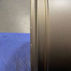 Close-up of bronze Owl Mojo Sprinter wheel rim with minor scuffs on a blue surface