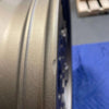 Close-up of a bronze Owl Mojo Sprinter wheel with minor scuffs and a small dent on the rim edge, showing its rugged aluminum finish.