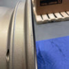 Close-up of an open box bronze Owl Mojo Sprinter wheel with minor scuffs and scratches on the rim surface