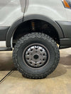 Talon Transit AWD wheel in graphite grey with rugged off-road tire on Ford Transit van, open box condition with minor scuffs.
