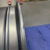 Close-up of a graphite grey Talon Transit AWD wheel rim with minor scuffs and scratches showing an open box condition.