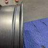 Graphite grey Talon Transit AWD wheel rim with minor scuffs on a blue padded surface.