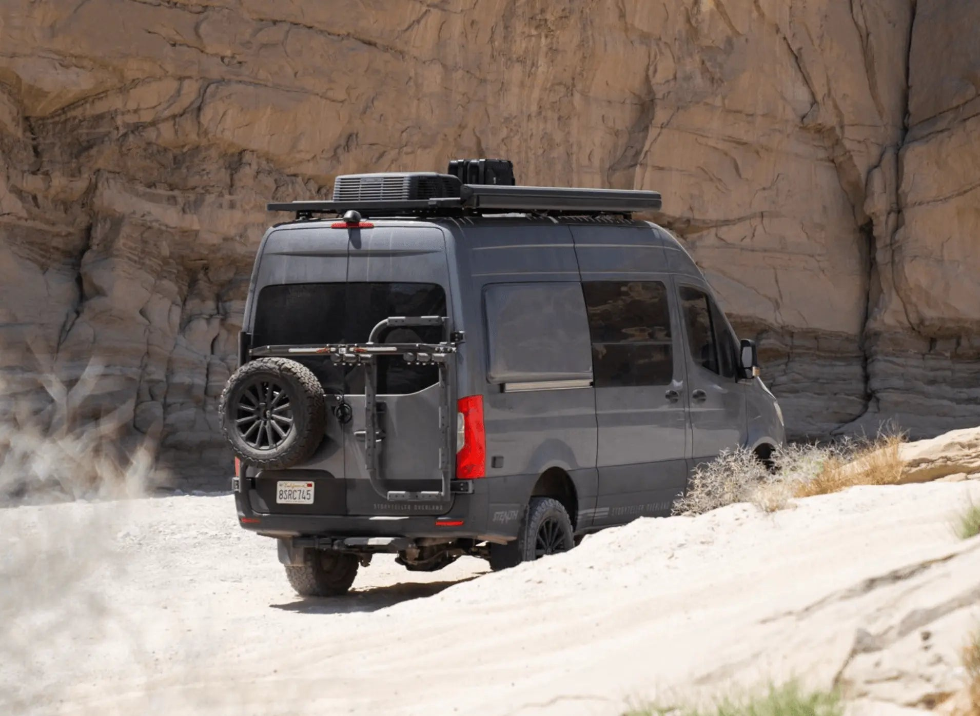 Bike rack and box carrier on a 2019+ Sprinter VS30 van in desert landscape.