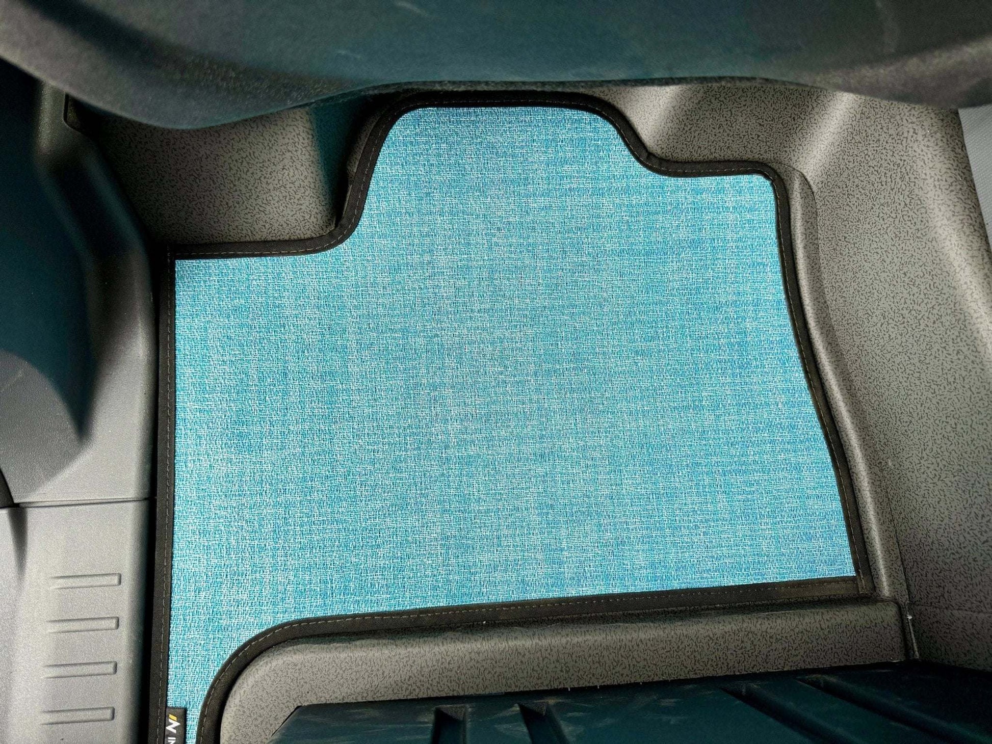 Custom floor mats for INEOS Grenadier in vehicle, tailored fit for protection and comfort.
