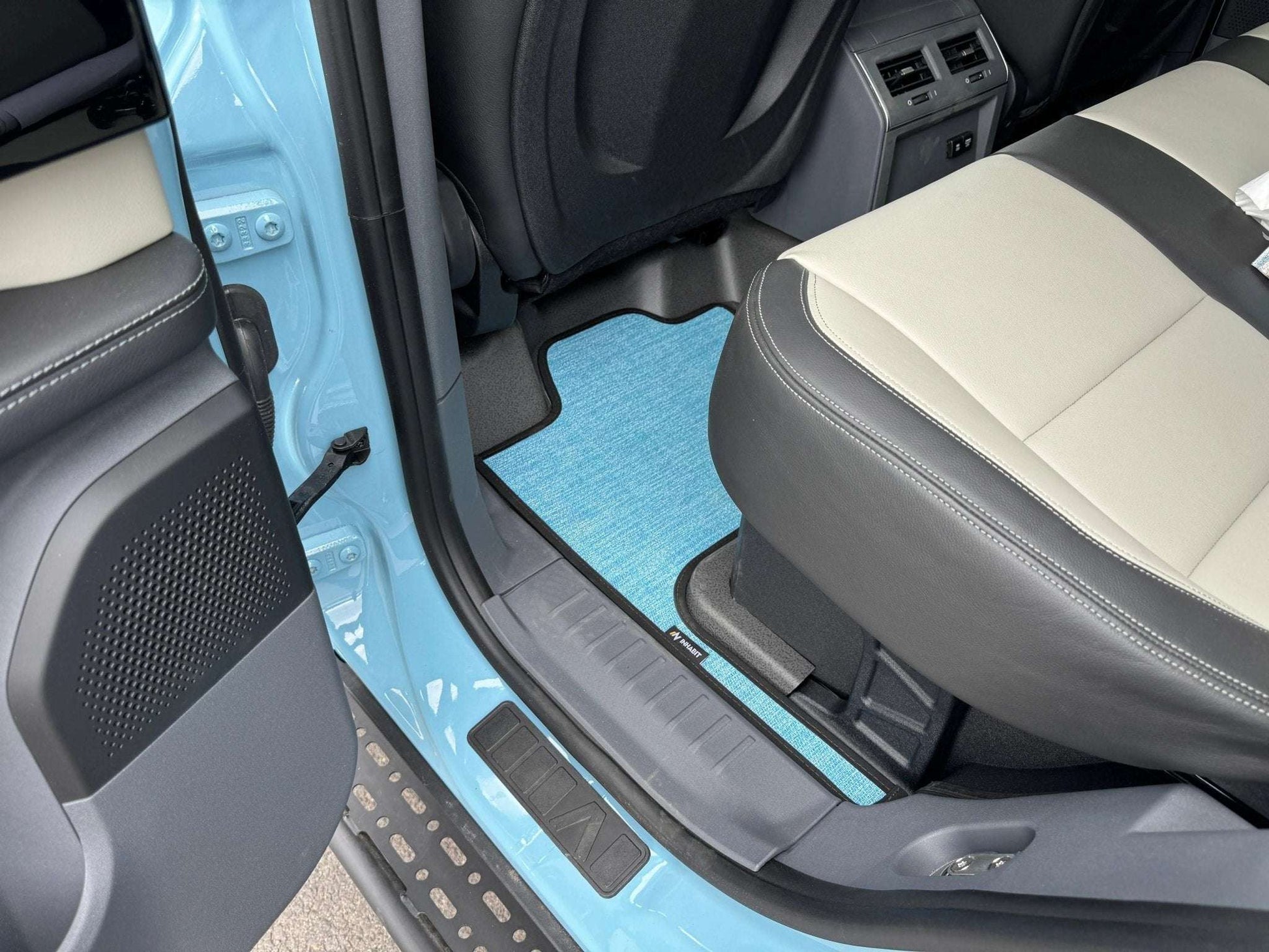 Custom floor mats for INEOS Grenadier interior, designed for comfort and protection, fitted precisely to trap dirt and debris.