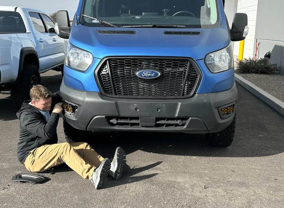 Fog Light Bracket installation on blue Transit van for enhanced durability and utility.