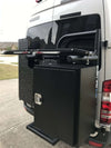 Large black aluminum Large Cargo Box mounted on the rear carrier of a white van for secure outdoor gear storage