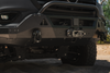 Close-up of black 9-ton aluminum D-shackle set with owl logo mounted on off-road vehicle bumper for heavy-duty recovery