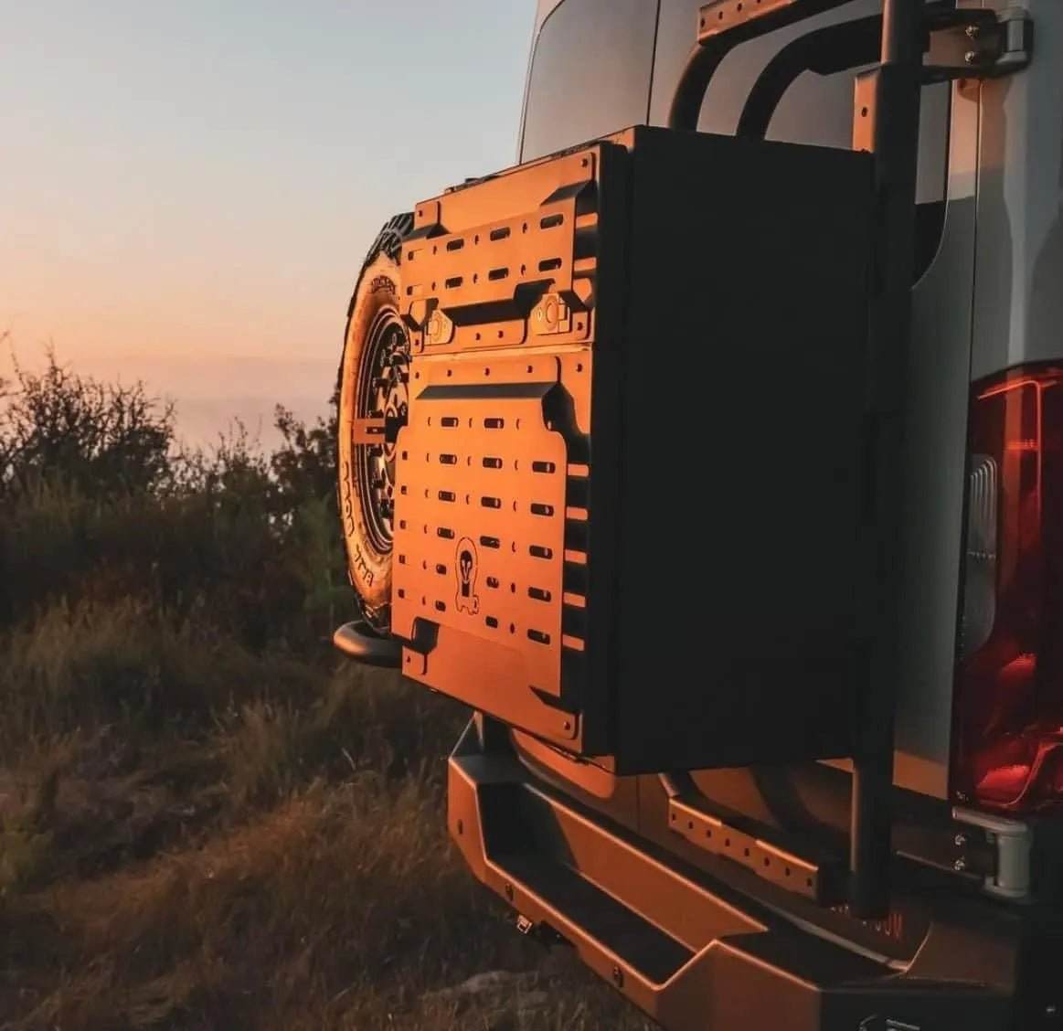 Black Monster 30 van storage box mounted on a vehicle at sunset for outdoor adventure use