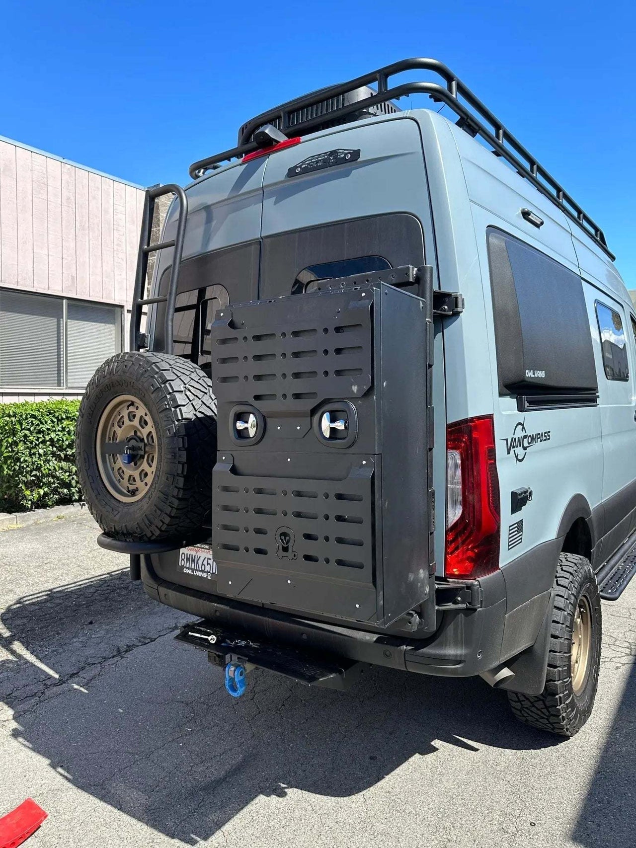 Van Storage Box Monster 40 mounted on rear door of off-road van with spare tire and roof rack
