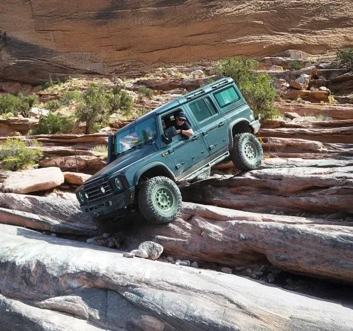 Grenadier Suspension - Off-road vehicle equipped with Owl 4" Lift TrailFlo Suspension navigating rocky terrain