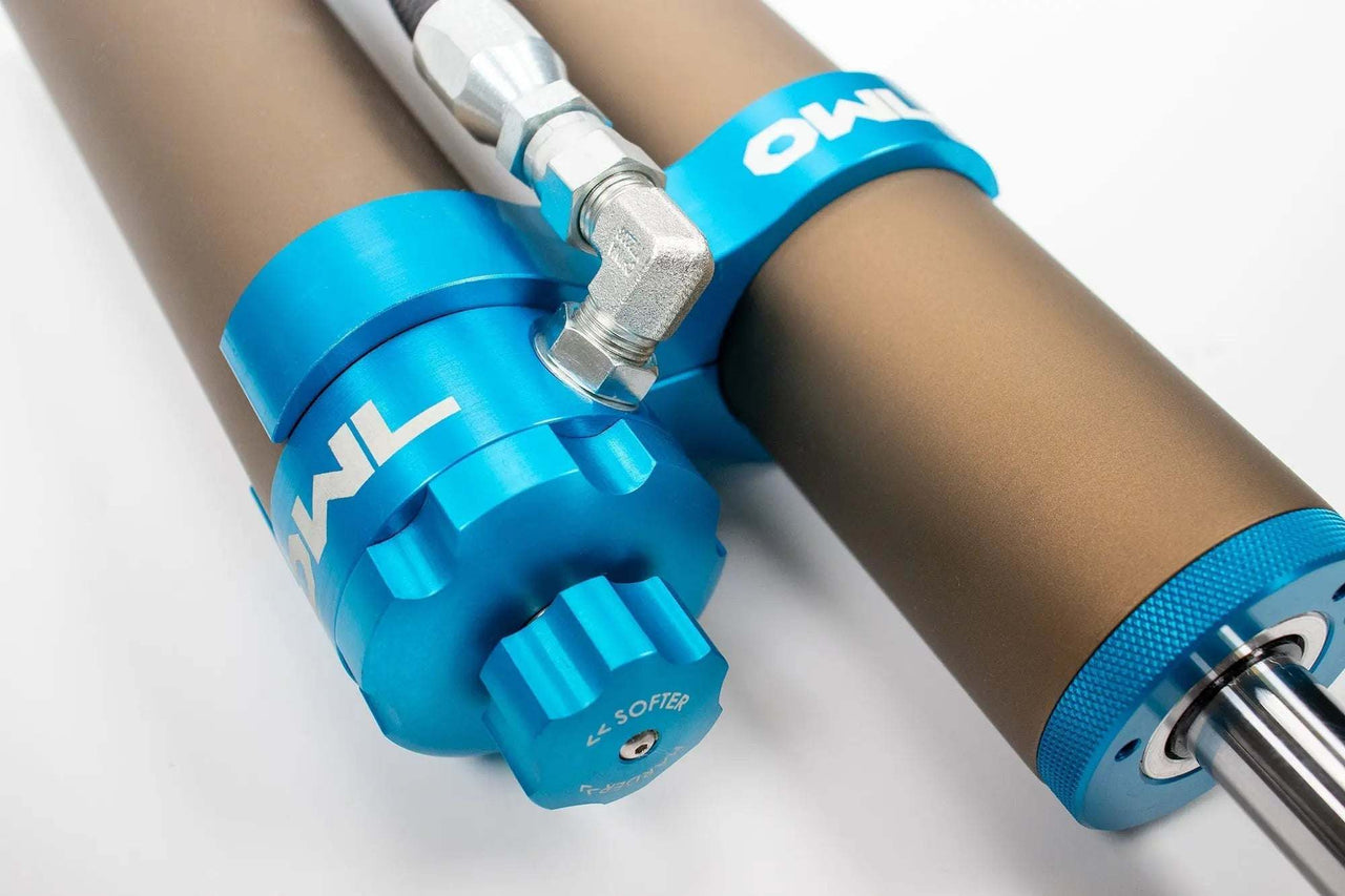 Grenadier Suspension - Close-up of Owl 4" Lift TrailFlo Suspension shock absorber with blue anodized components for INEOS