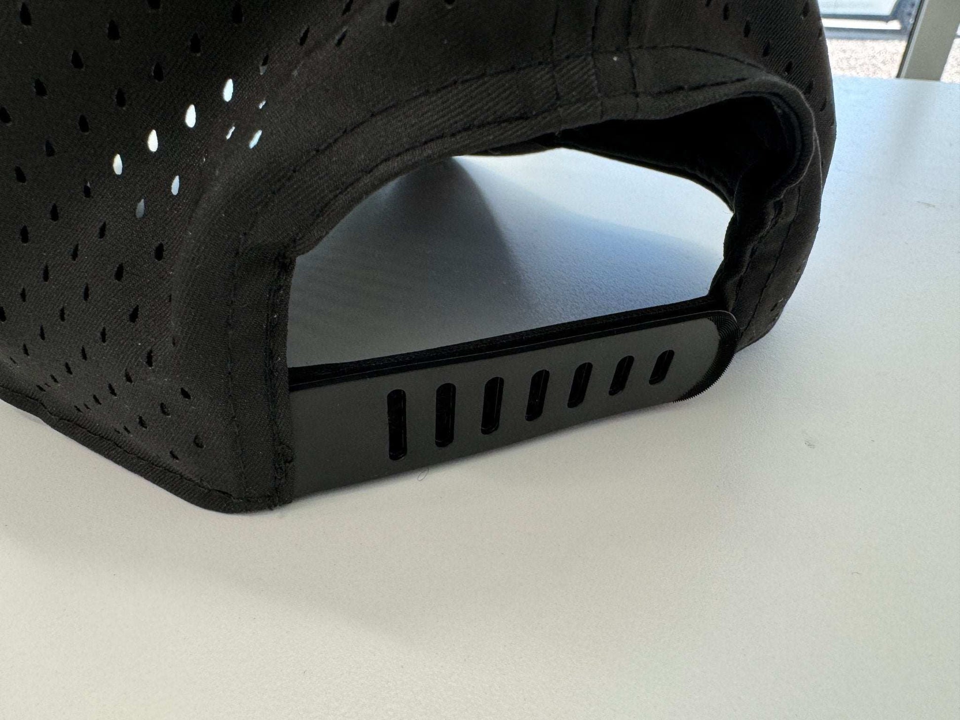Back view of black Owl Waterproof Hat with adjustable strap made from recycled plastic bottles, eco-friendly and soft material.