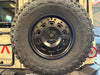 Rear Camera Relocation Kit for INEOS Grenadier with tire and harness installed.