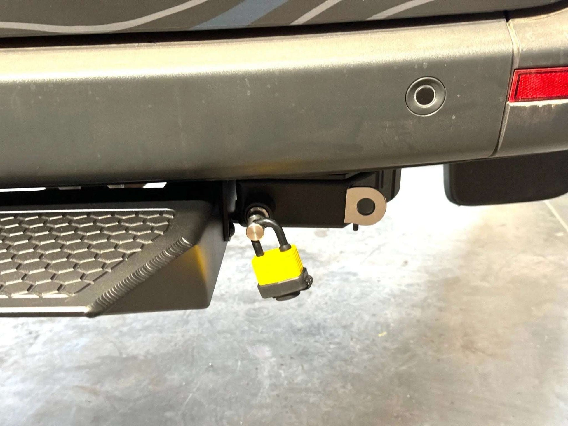 Retractable bike and gear lock attached to vehicle for adventure use.