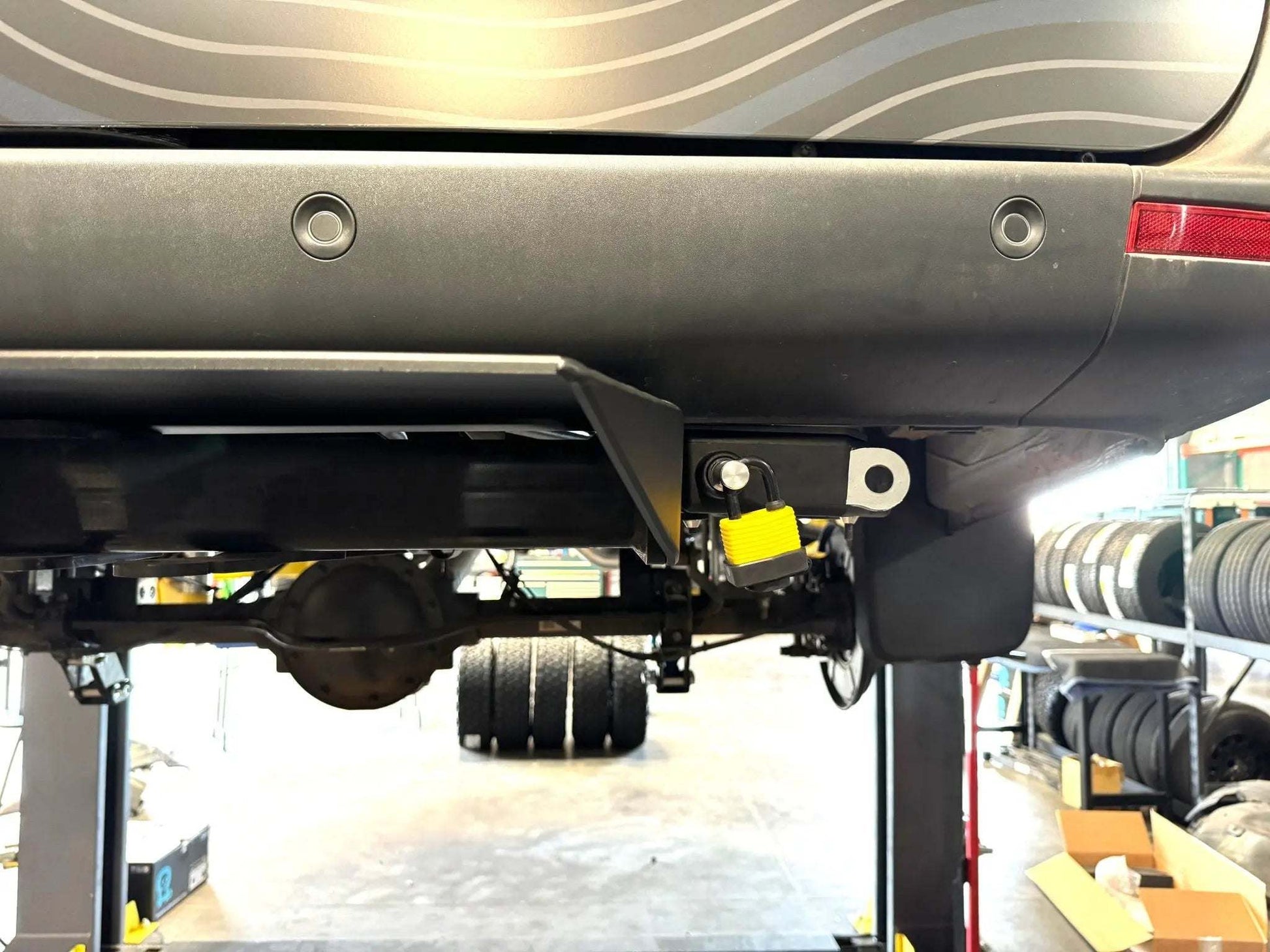 Retractable bike and gear lock installed on a Sprinter vehicle for secure adventure-ready setup.