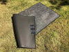 Small outdoor area rug on grass, suitable for camping and outdoor use.