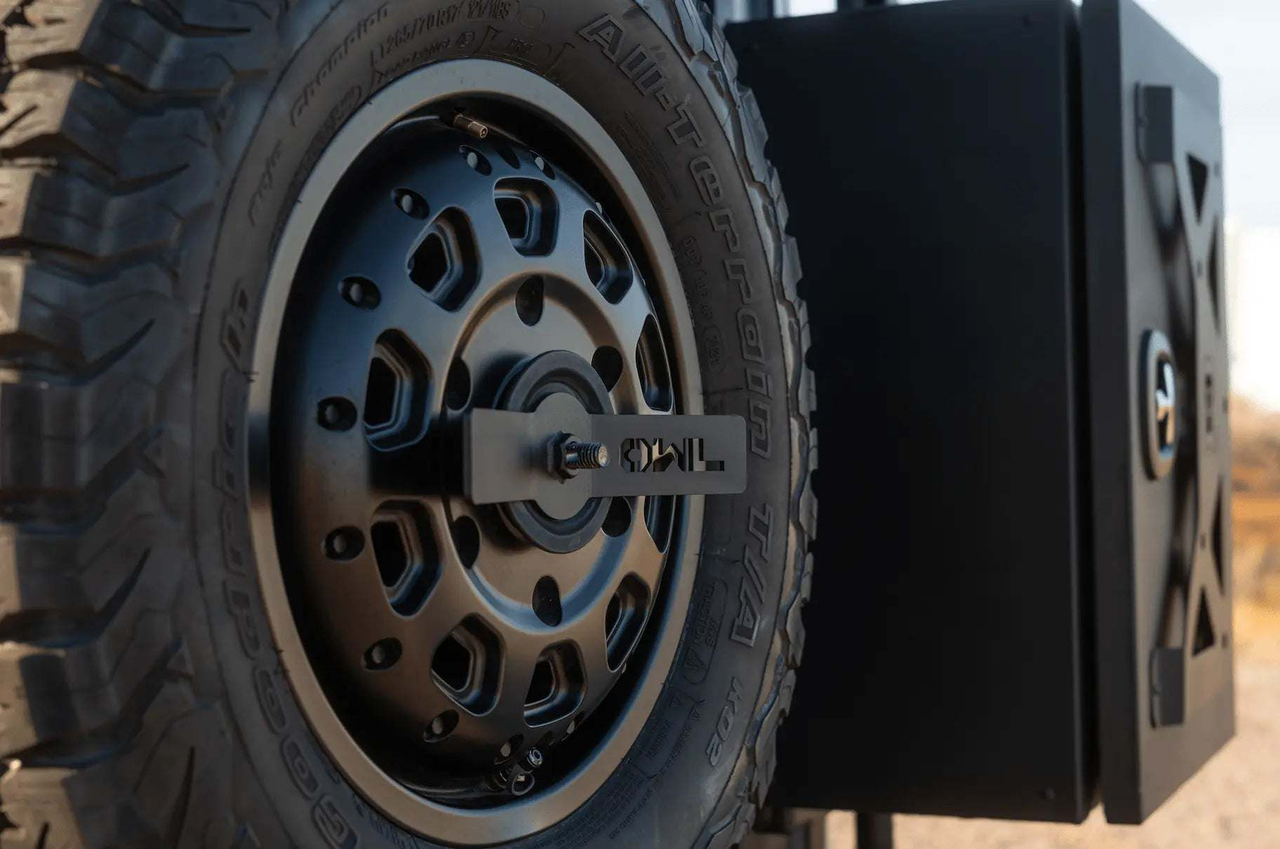 Owl rear door spare tire carrier next to a large cargo box