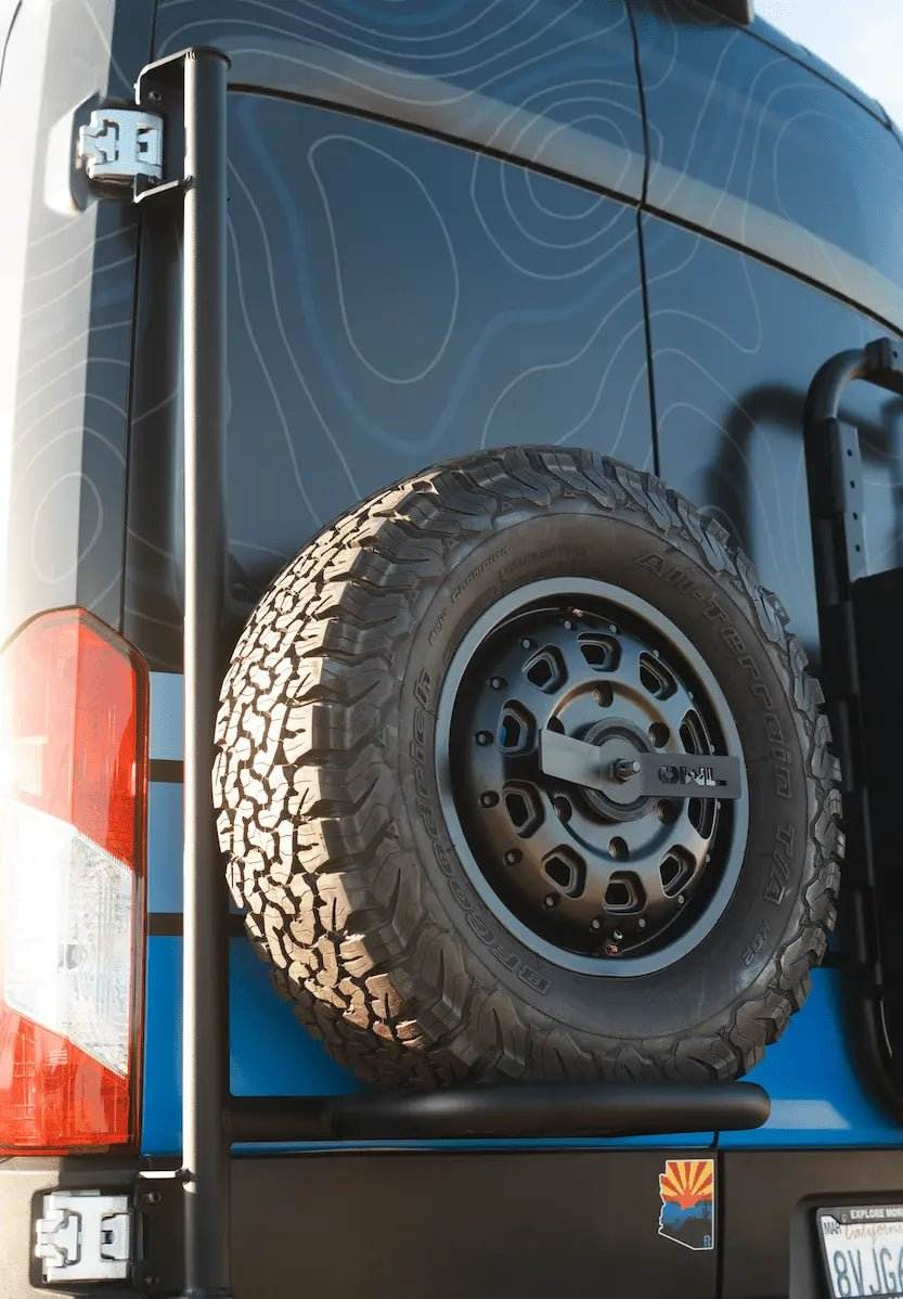 Close up of Owl rear door spare tire carrier mounted on the rear doors of a Ford Transit