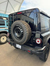 Tire relocation bracket on INEOS Grenadier for off-road utility.