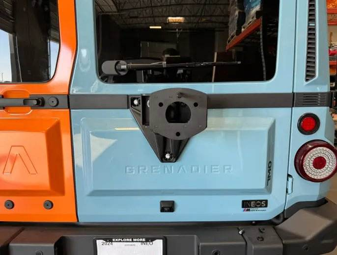Tire relocation bracket installed on INEOS Grenadier rear door.