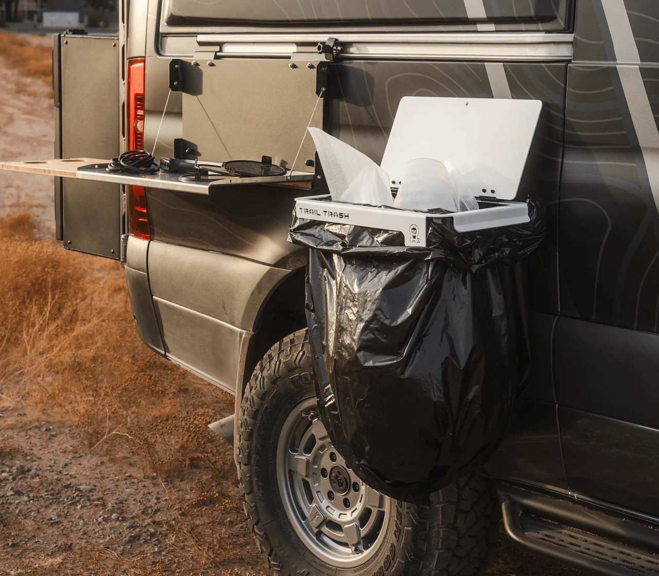Magnetic Trail Trash holder attached to off-road vehicle with black trash bag for overlanding camping cleanup