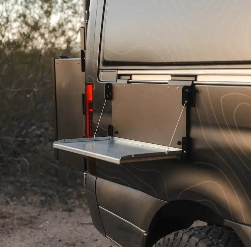 Trax Table mounted on off-road vehicle with fold-out design for outdoor adventure use