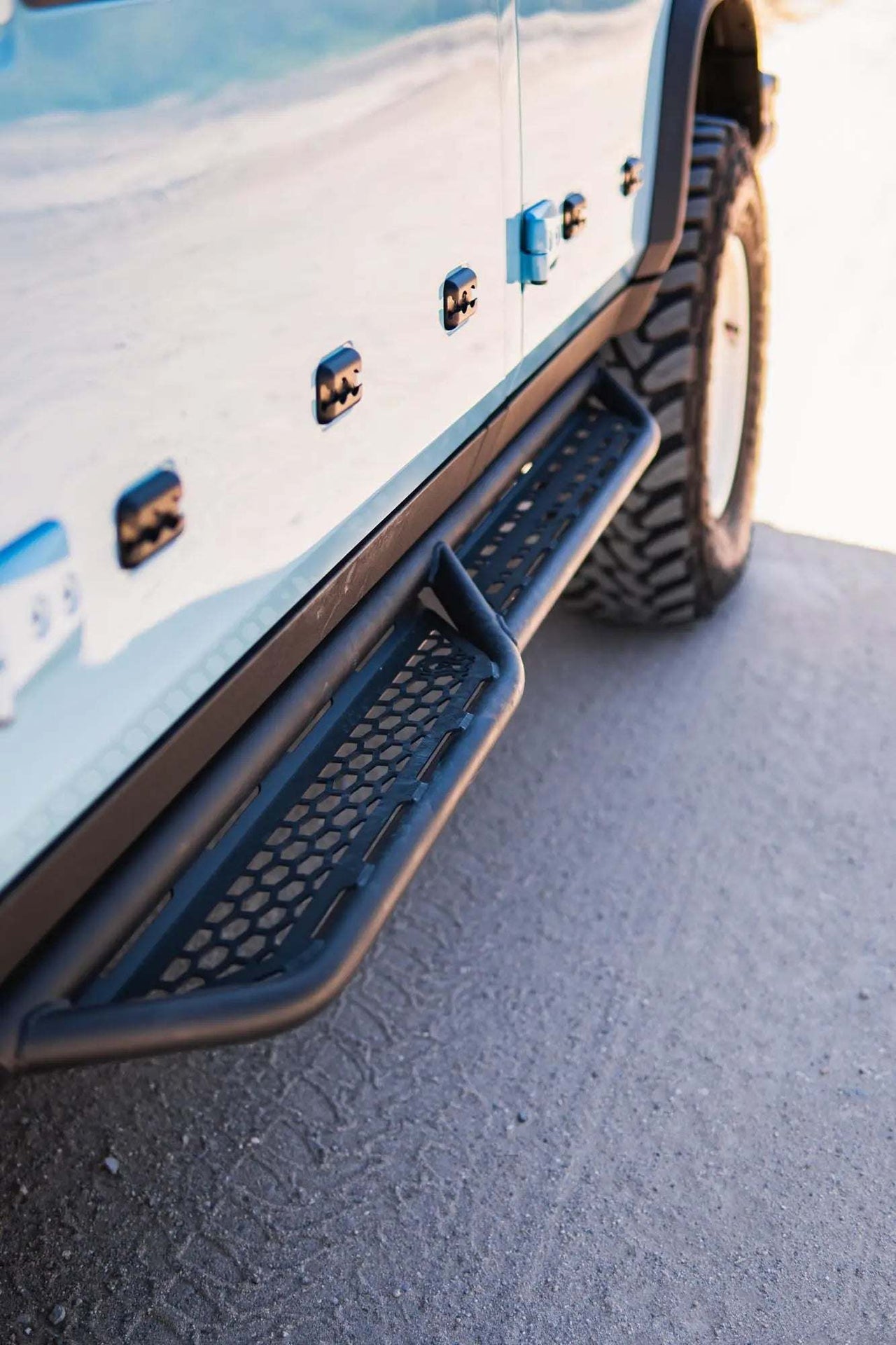 Tubular Grenadier Side Steps and Rock Sliders installed on off-road vehicle