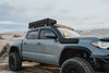 83L Rugged Mount securing a sturdy black rugged case on a grey off-road truck roof rack in desert terrain