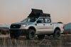 Ford pickup truck with 83L Rugged Mount roof rack case in outdoor setting