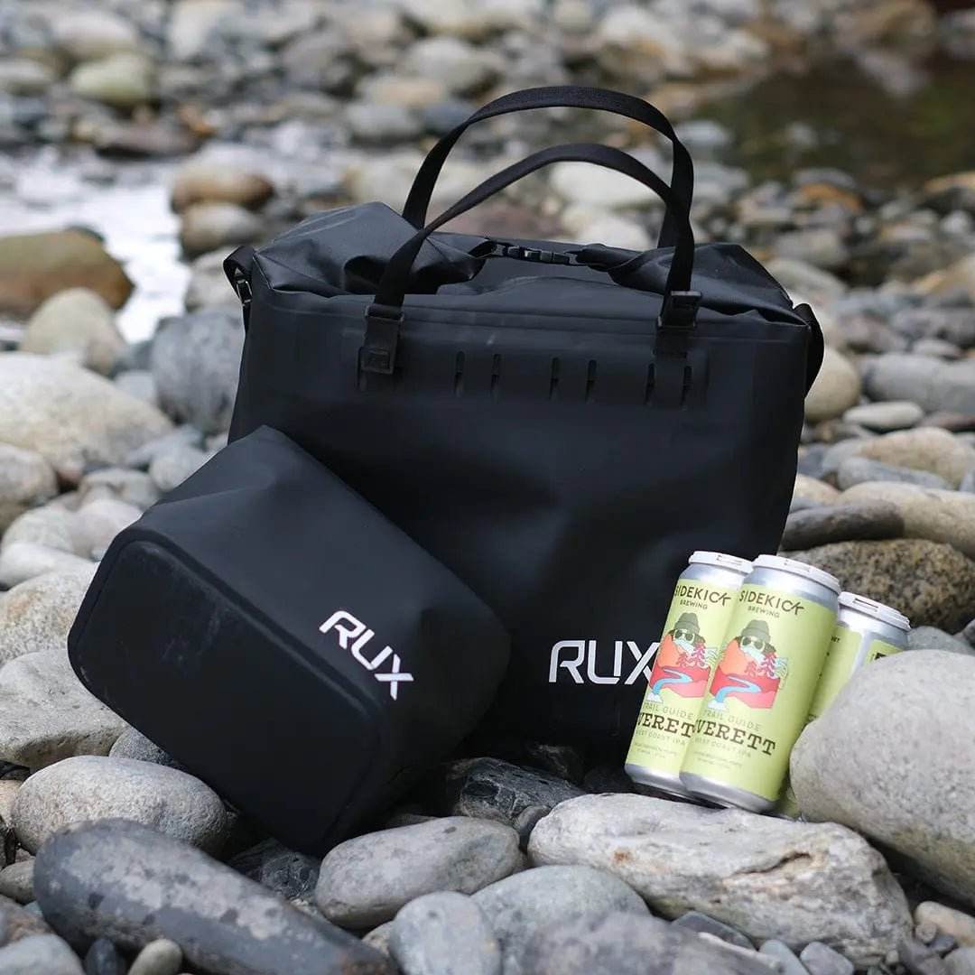 25L Soft Cooler Bag on rocky riverbed with drinks, designed for durability and adventure.