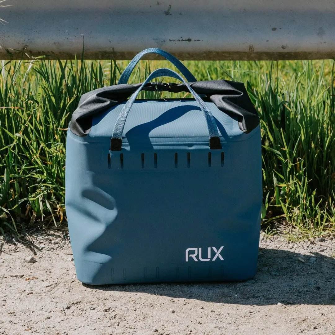 25L Soft Cooler Bag by RUX outdoors on grass with durable design.