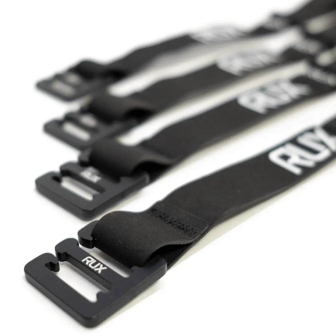 Black RUX tie-down straps with durable metal buckles for secure outdoor utility and overland setups