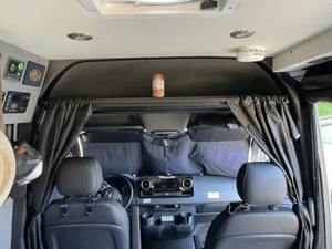 Sprinter van interior showing black powder coat headliner shelf above driver and passenger seats for added storage.