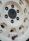Close-up of a beige off-road vehicle wheel equipped with XL Rapid Deflator Valve for quick tire pressure adjustment.