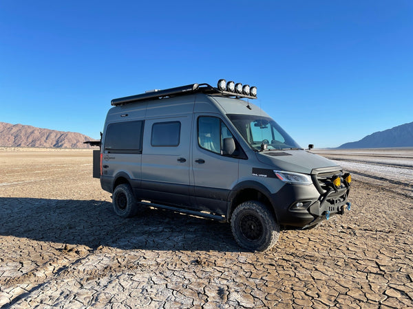Side of Van Compass with lift kit in the desert