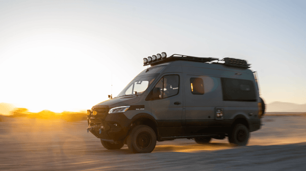 Side view of Van Compass with lift kit in the desert